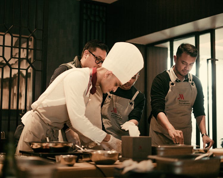 Marcos Pizza team members in the restaurant kitchen
